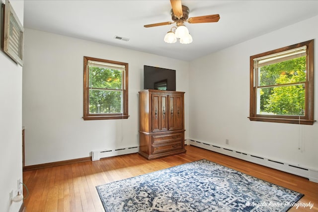 2514 Cuhlman Rd, Mchenry, IL 60051 - bedroom with a baseboard heating unit, multiple windows, and light wood-style floors
