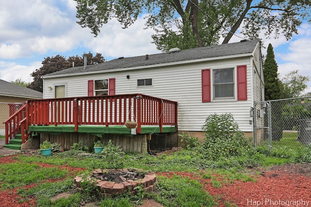 1912 Oak Dr, Mchenry, IL 60050 - rear view of house featuring an outdoor fire pit and a wooden deck