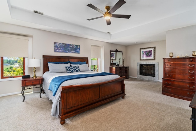 17642 Crystal Lake Dr, Homer Glen, IL 60491 - bedroom with carpet floors, a raised ceiling, a high end fireplace, and a ceiling fan