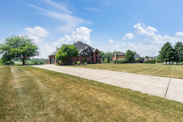 17642 Crystal Lake Dr, Homer Glen, IL 60491 - tudor home with concrete driveway, a front yard, and an attached garage