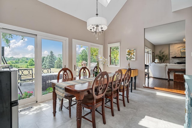 17642 Crystal Lake Dr, Homer Glen, IL 60491 - dining room featuring a chandelier, high vaulted ceiling, and a skylight