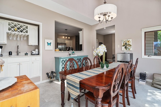 17642 Crystal Lake Dr, Homer Glen, IL 60491 - dining room with bar with sink, a chandelier, and light tile patterned floors