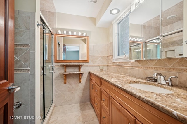 36 Logan Ter, Golf, IL 60029 - full bathroom with a shower stall, vanity, and tile walls