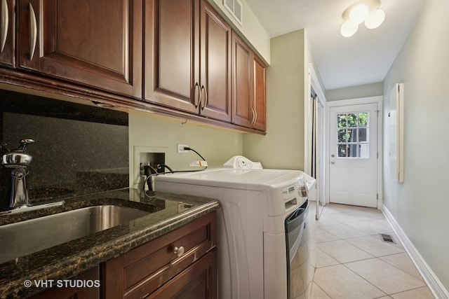 36 Logan Ter, Golf, IL 60029 - washroom featuring washing machine and dryer, light tile patterned floors, and cabinet space