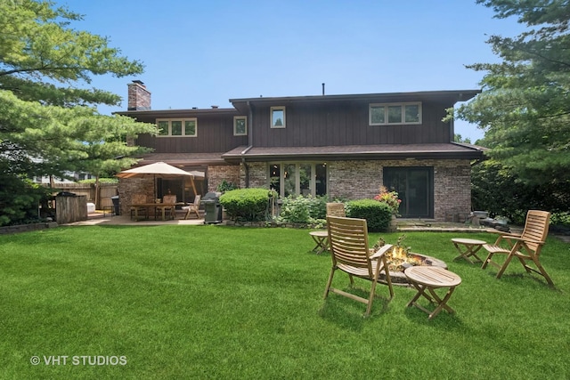 36 Logan Ter, Golf, IL 60029 - back of house with a fire pit, a chimney, and a patio