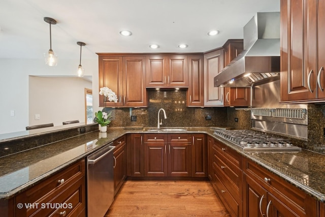 36 Logan Ter, Golf, IL 60029 - kitchen with wall chimney exhaust hood, appliances with stainless steel finishes, decorative light fixtures, decorative backsplash, and light wood-type flooring
