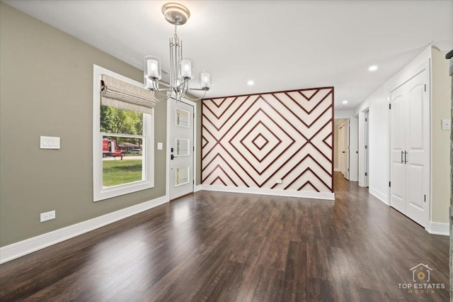1702 Winthrop Ln, Schaumburg, IL 60193 - unfurnished room featuring a chandelier, dark wood-type flooring, an accent wall, and recessed lighting