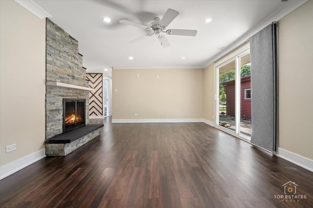 1702 Winthrop Ln, Schaumburg, IL 60193 - unfurnished living room featuring dark wood-type flooring, ornamental molding, a stone fireplace, a ceiling fan, and recessed lighting
