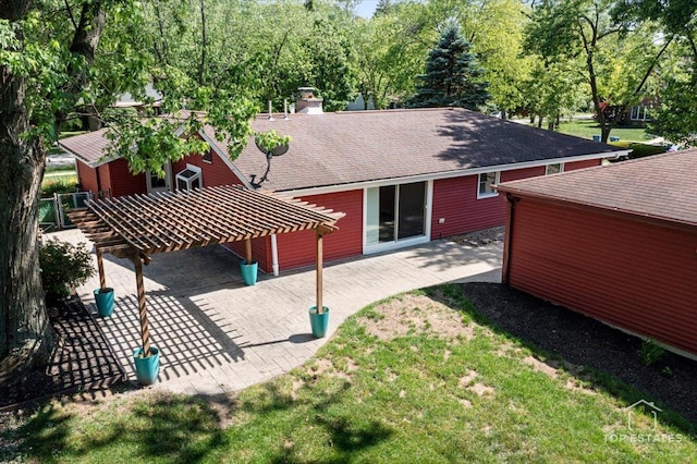 1702 Winthrop Ln, Schaumburg, IL 60193 - back of house featuring a shingled roof, a yard, a patio, and a chimney