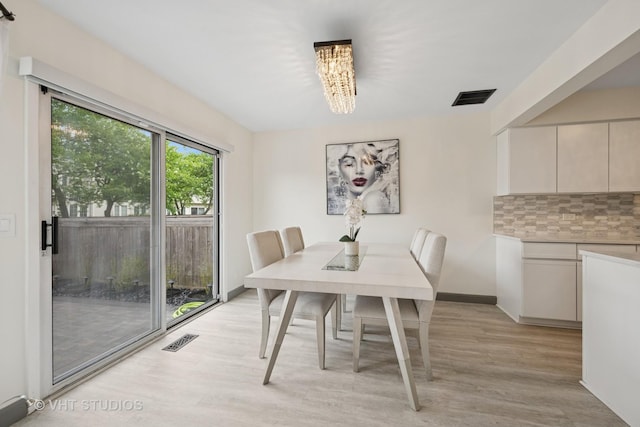 707 Sturnbridge Ln, Schaumburg, IL 60173 - dining area with light wood finished floors and a chandelier