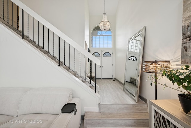 707 Sturnbridge Ln, Schaumburg, IL 60173 - entrance foyer featuring a high ceiling, wood finished floors, and stairway