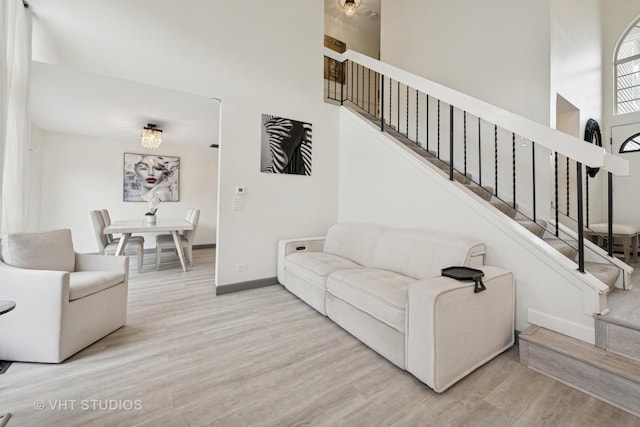 707 Sturnbridge Ln, Schaumburg, IL 60173 - living area featuring stairs, wood finished floors, and a high ceiling