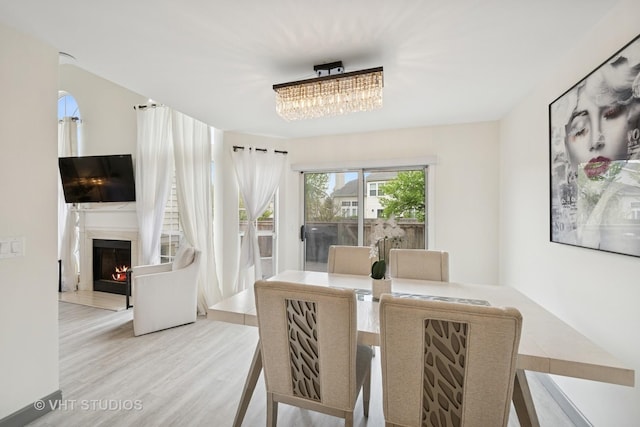 707 Sturnbridge Ln, Schaumburg, IL 60173 - dining space with a warm lit fireplace and wood finished floors
