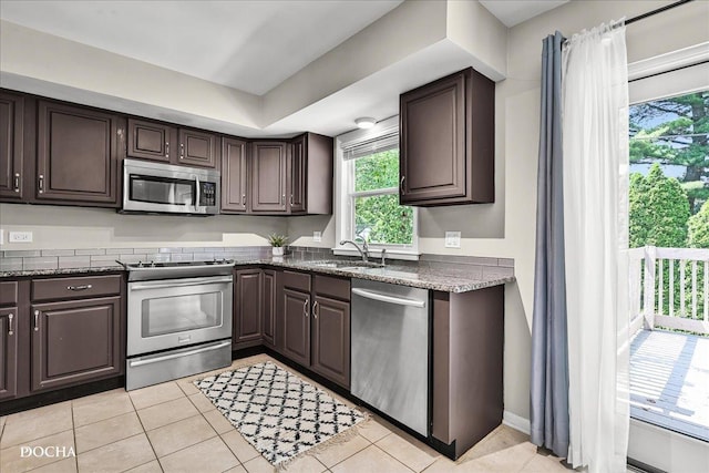 425 W Gartner Rd, Naperville, IL 60540 - kitchen with appliances with stainless steel finishes, dark brown cabinetry, and light tile patterned floors