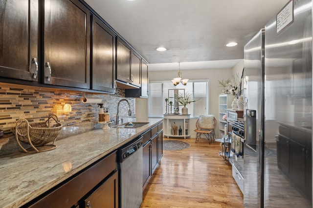641 Sundance Dr, Bolingbrook, IL 60440 - kitchen with appliances with stainless steel finishes, dark brown cabinetry, light wood-style flooring, recessed lighting, and light stone countertops