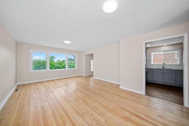 476 W 17th St, Chicago Heights, IL 60411 - unfurnished living room featuring light wood finished floors and baseboards