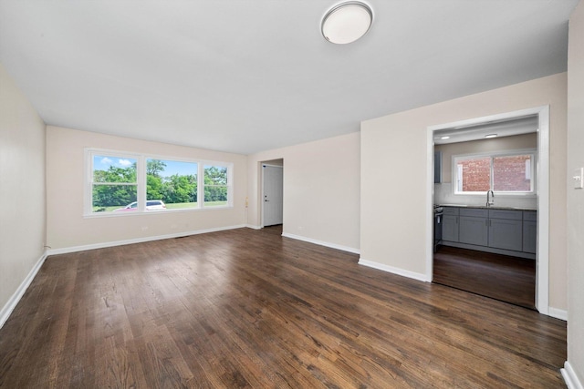 476 W 17th St, Chicago Heights, IL 60411 - unfurnished living room with dark wood-type flooring and baseboards