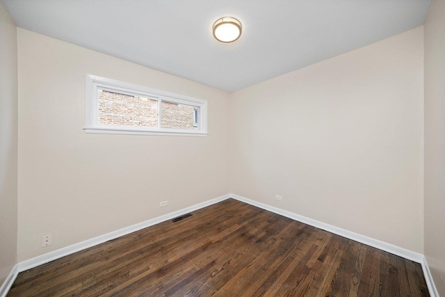 476 W 17th St, Chicago Heights, IL 60411 - empty room featuring baseboards and dark wood-type flooring