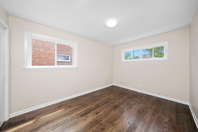 476 W 17th St, Chicago Heights, IL 60411 - unfurnished bedroom with baseboards and dark wood-style floors