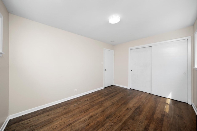 476 W 17th St, Chicago Heights, IL 60411 - unfurnished bedroom featuring dark wood-style flooring and a closet