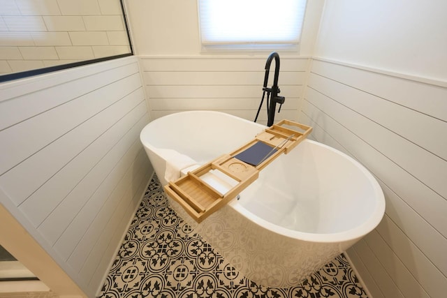 671 Teal Ct, Dekalb, IL 60115 - bathroom with a soaking tub, tile patterned flooring, wainscoting, and wooden walls