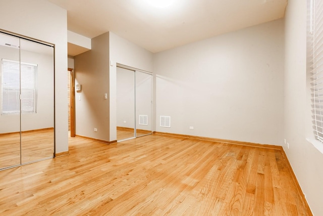 4137 S Prairie Ave Unit 1S, Chicago, IL 60653 - unfurnished bedroom with two closets and light wood-style flooring