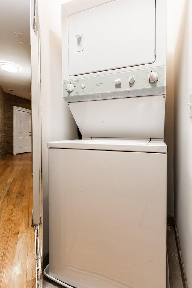 4137 S Prairie Ave Unit 1S, Chicago, IL 60653 - laundry area featuring stacked washer and clothes dryer and wood finished floors