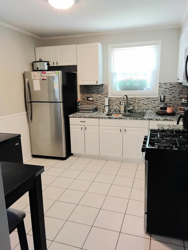 42 Sauk Trl, Park Forest, IL 60466 - kitchen featuring stainless steel appliances, light stone countertops, white cabinets, decorative backsplash, and ornamental molding