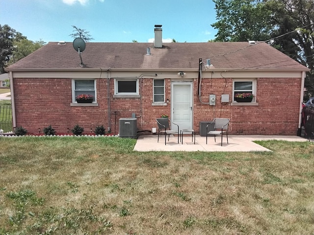42 Sauk Trl, Park Forest, IL 60466 - back of house featuring brick siding, a patio area, a chimney, and a shingled roof