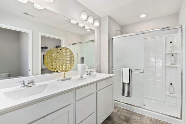 6913 Willow Dr, Wonder Lake, IL 60097 - full bath featuring a shower stall, double vanity, recessed lighting, and stone finish floors