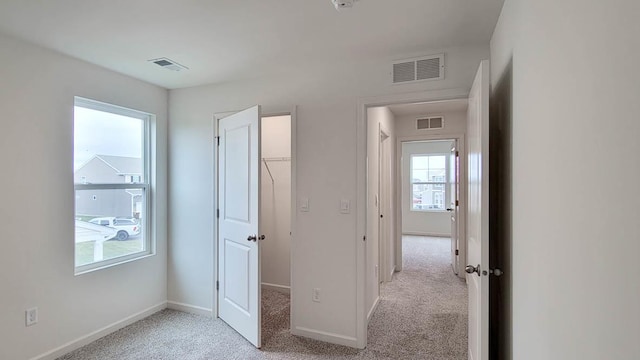6913 Willow Dr, Wonder Lake, IL 60097 - unfurnished bedroom featuring multiple windows, light colored carpet, and a spacious closet