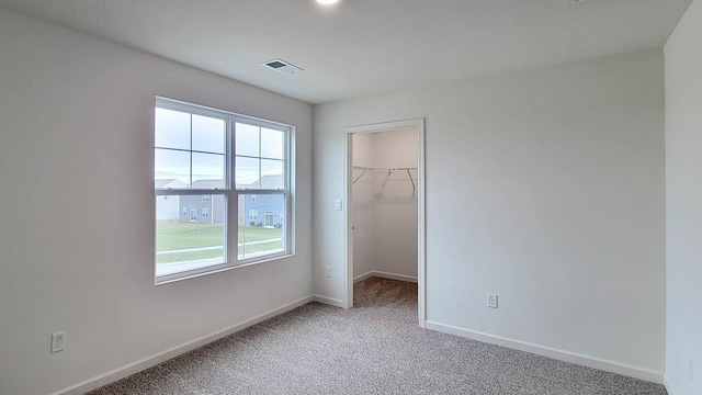6913 Willow Dr, Wonder Lake, IL 60097 - unfurnished bedroom with light carpet, a spacious closet, and a closet