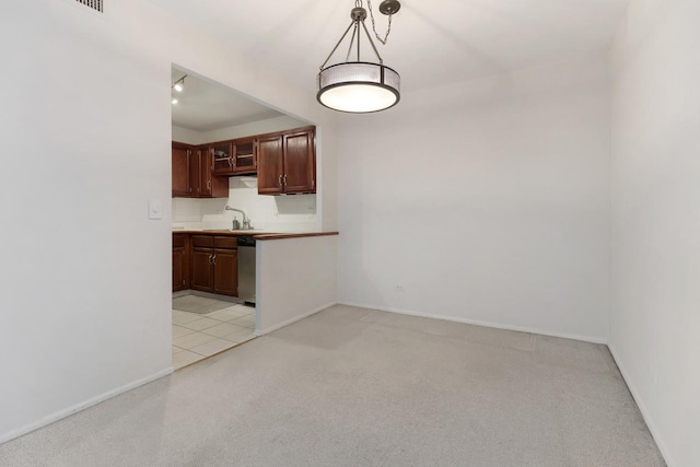 850 Wellington Ave Unit 311, Elk Grove Village, IL 60007 - kitchen featuring dishwasher, light colored carpet, and decorative light fixtures