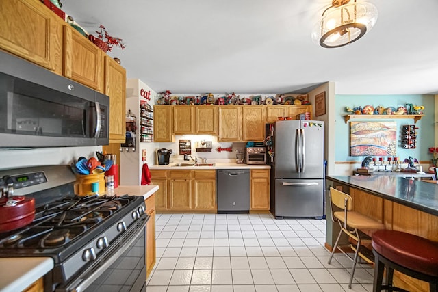 5613 W Von Ave, Monee, IL 60449 - kitchen featuring appliances with stainless steel finishes, light tile patterned floors, brown cabinets, and light countertops