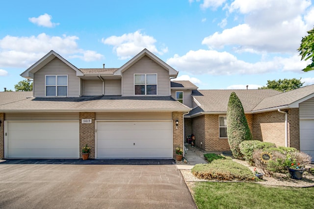 5613 W Von Ave, Monee, IL 60449 - view of front of house with brick siding, an attached garage, driveway, and a shingled roof