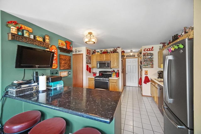 5613 W Von Ave, Monee, IL 60449 - kitchen featuring appliances with stainless steel finishes, light tile patterned floors, a peninsula, and a kitchen breakfast bar