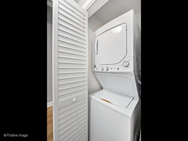 1632 S Indiana Ave Unit 304, Chicago, IL 60616 - washroom with stacked washer and clothes dryer and wood finished floors