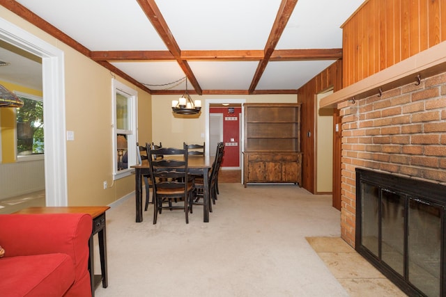 24503 Iroquois Ln, Hudson, IL 61748 - dining area with a brick fireplace, a chandelier, beamed ceiling, light colored carpet, and coffered ceiling