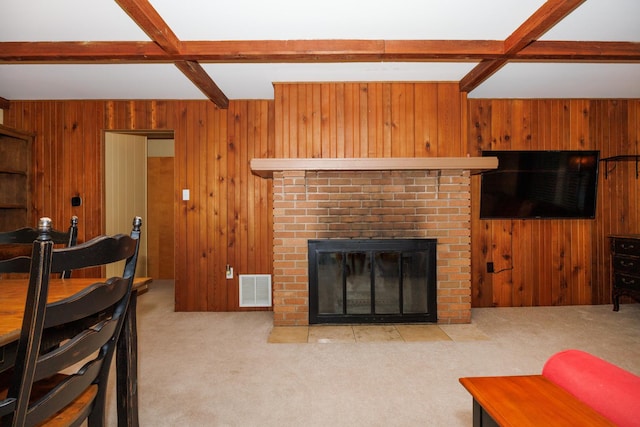 24503 Iroquois Ln, Hudson, IL 61748 - living room with wooden walls, carpet, beamed ceiling, and a fireplace