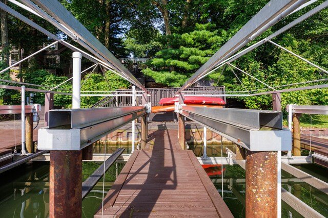 24503 Iroquois Ln, Hudson, IL 61748 - dock area with boat lift and view of wooded area