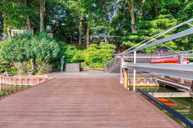 24503 Iroquois Ln, Hudson, IL 61748 - dock featuring view of scattered trees, a deck, and stairs
