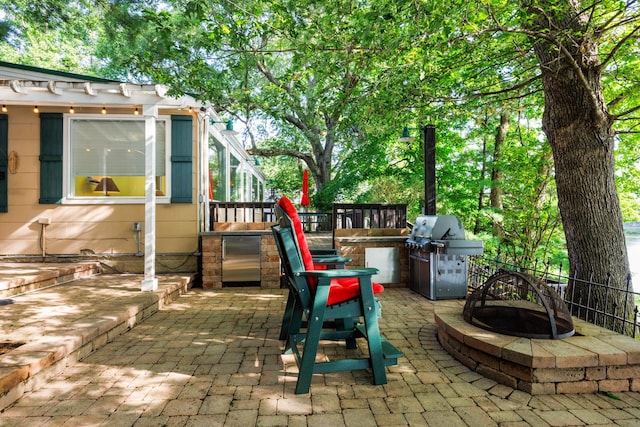 24503 Iroquois Ln, Hudson, IL 61748 - view of patio featuring a fire pit and area for grilling