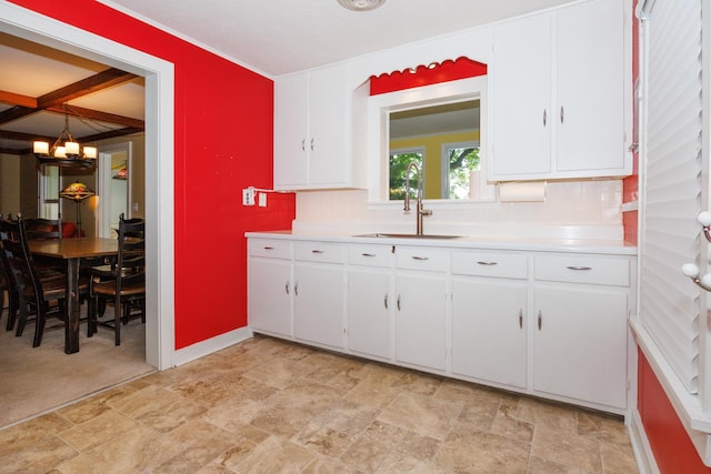 24503 Iroquois Ln, Hudson, IL 61748 - kitchen with a chandelier, light countertops, stone finish floors, and backsplash
