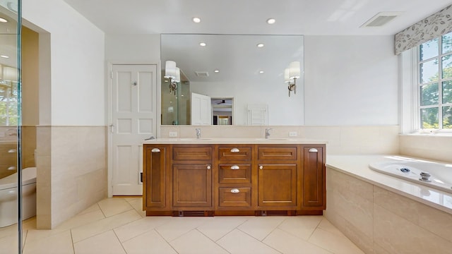 570 Hathaway Cir, Lake Forest, IL 60045 - full bath with tile patterned floors, double vanity, a bath, a shower stall, and recessed lighting