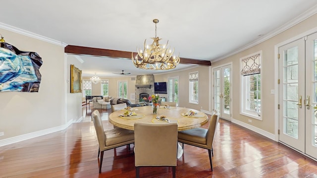 570 Hathaway Cir, Lake Forest, IL 60045 - dining room featuring a chandelier, wood finished floors, ornamental molding, french doors, and a stone fireplace