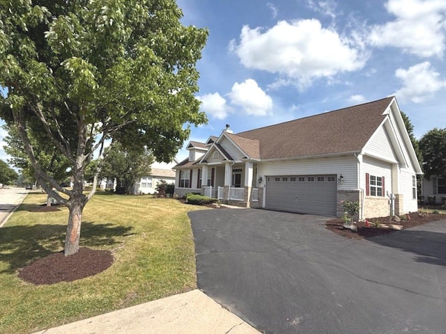 1711 Devonshire Ln, Shorewood, IL 60404 - view of front of house with a garage, driveway, a front yard, covered porch, and brick siding