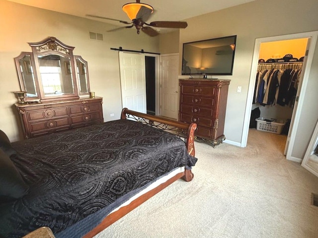 1711 Devonshire Ln, Shorewood, IL 60404 - carpeted bedroom featuring a barn door, a closet, a spacious closet, and a ceiling fan