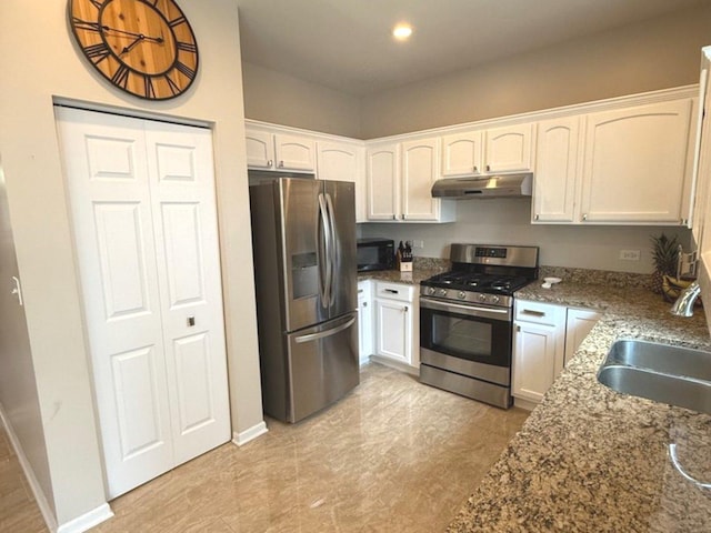 1711 Devonshire Ln, Shorewood, IL 60404 - kitchen with stainless steel appliances, under cabinet range hood, white cabinetry, dark stone counters, and recessed lighting