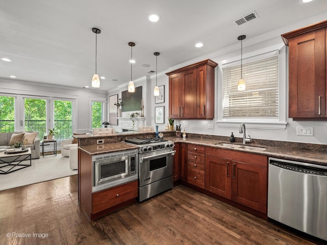 1541 W Montana St Unit 2, Chicago, IL 60614 - kitchen featuring appliances with stainless steel finishes, open floor plan, ornamental molding, a peninsula, and dark wood-type flooring