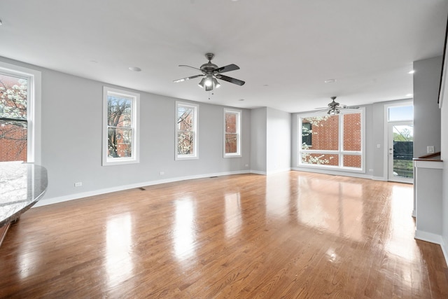 2864 N Riverwalk Dr, Chicago, IL 60618 - unfurnished living room featuring a ceiling fan and wood finished floors